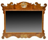 Lot 1471 - A walnut parcel gilt wall mirror, the carved...