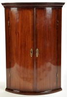 Lot 1490 - A George III mahogany bowfront hanging corner...