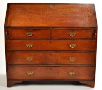 Lot 1512 - A Georgian oak bureau crossbanded in mahogany...