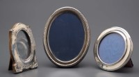 Lot 548 - An Elizabeth II oval silver photograph frame,...