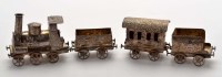 Lot 690 - An Edwardian silver model train, bears import...