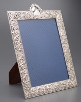 Lot 698 - A large white metal easel back photograph...