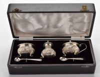 Lot 710 - A three-piece condiment set, chased and...