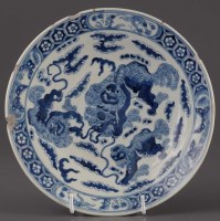 Lot 1024 - A blue and white charger, decorated with three...