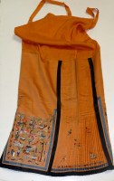 Lot 1032 - An orange silk robe, the lower section...