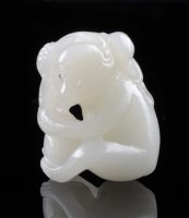 Lot 1033 - A fine white/pale celadon carved jade monkey...