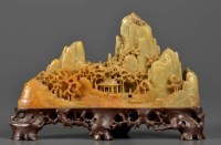 Lot 1037 - A carved soapstone 'mountain', the well carved...