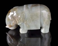 Lot 1038 - A large jade caparisoned elephant, the celadon...