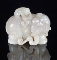 Lot 1040 - A jade group of a boy washing an elephant, the...