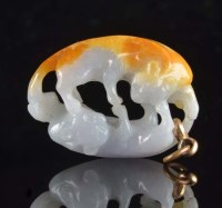 Lot 1041 - A jade pendant carved as two cats, the oval...