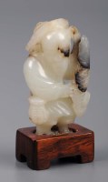 Lot 1043 - A pale Celadon jade figure, 18th Century,...