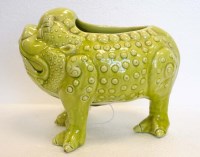 Lot 1119 - Burmantoft: a lime green glazed three legged...