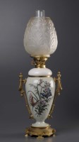 Lot 1125 - A Celadon glazed and metal mounted oil lamp,...