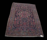 Lot 1174 - A mid-20th Century Kirman rug, with floral...