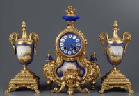 Lot 1189 - A French gilt metal and porcelain three-piece...