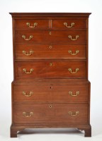 Lot 1242 - A Georgian mahogany tallboy, with flared...