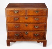 Lot 1283 - A small Georgian style walnut chest of two...