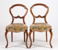 Lot 1293 - A pair of Victorian walnut balloon-back dining...