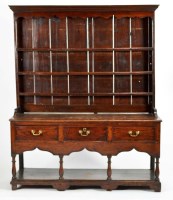 Lot 1313 - An early Georgian oak dresser with three-tier...