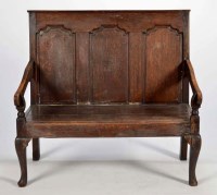 Lot 1319 - An 18th Century oak settle, the tall fielded...