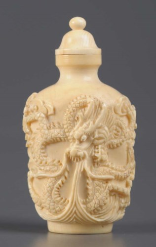 Lot 44 - A carved ivory snuff bottle, carved with twin...