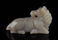 Lot 46 - A celadon jade horse, the recumbent beast with...
