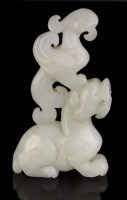Lot 48 - A carved pale celadon jade lion and phoenix,...
