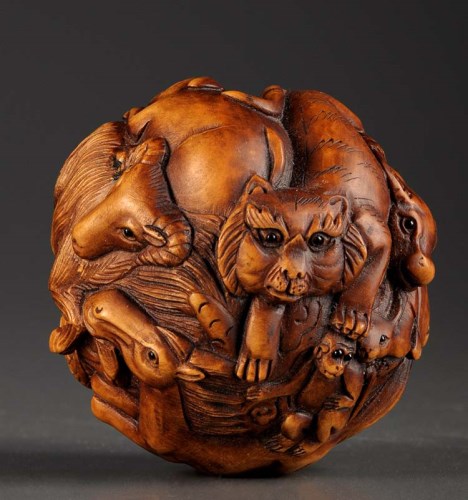 Lot 51 - A carved and stained wooden 'Zodiac' ball,...