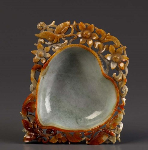 Lot 57 - A jade bowl of peach form, surrounded by...
