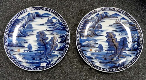 Lot 73 - A pair of plaques, painted in blue and gold...