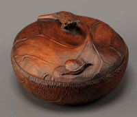 Lot 86 - A carved wooden circular box, fashioned as an...