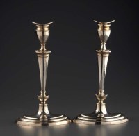 Lot 602 - A pair of Edwardian candlestick, by the...