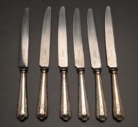 Lot 616 - A set of twelve plated table knives, by...