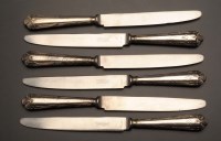 Lot 625 - A set of twelve plated table knives, the...