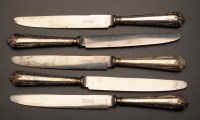 Lot 631 - Eleven plated table knives, the handles with...