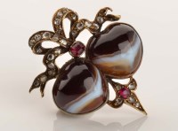 Lot 857 - An agate, diamond and ruby brooch, the two...