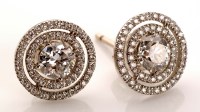 Lot 859 - A pair of diamond earrings, each central...