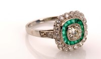 Lot 867 - An emerald and diamond cluster ring, the...