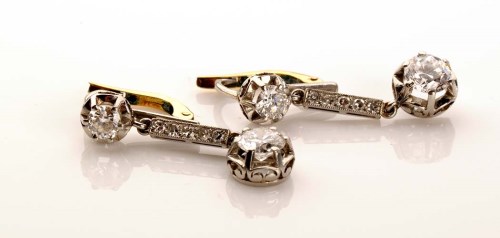 Lot 868 - A pair of Edwardian diamond earrings, each set...