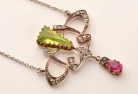 Lot 891 - An Art Nouveau peridot, diamond and tourmaline...