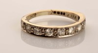 Lot 902 - A half-hoop eternity ring, the nine brilliant...