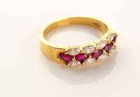 Lot 923 - A ruby and diamond half hoop eternity ring,...