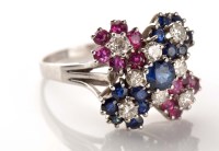 Lot 930 - A ruby, diamond and sapphire cluster ring, the...