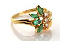 Lot 931 - An emerald and diamond dress ring, the four...