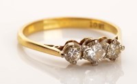 Lot 940 - A three stone diamond ring, the three slightly...