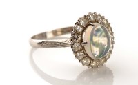 Lot 948 - An opal and diamond ring, c.1900, the oval...