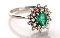 Lot 950 - An emerald and diamond cluster ring, the oval...