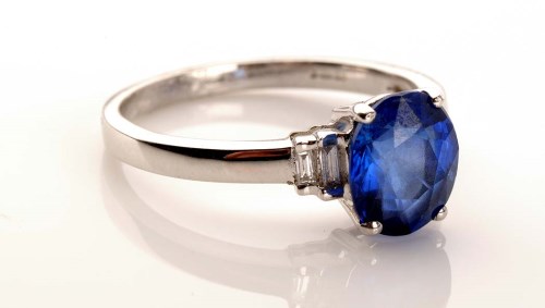 Lot 967 - A sapphire and diamond ring, the oval mixed...