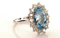 Lot 969 - An aquamarine and diamond cluster ring, the...