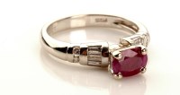 Lot 985 - A ruby and diamond ring, the oval mixed cut...